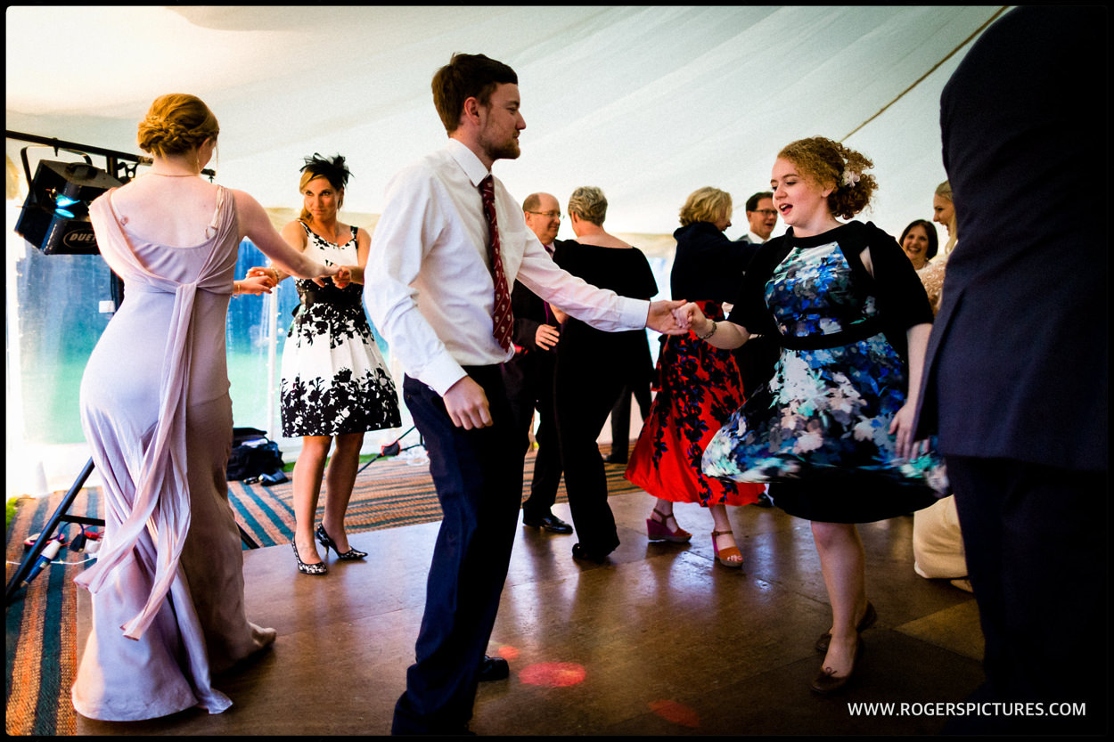 Wedding guests dancing in a marquee