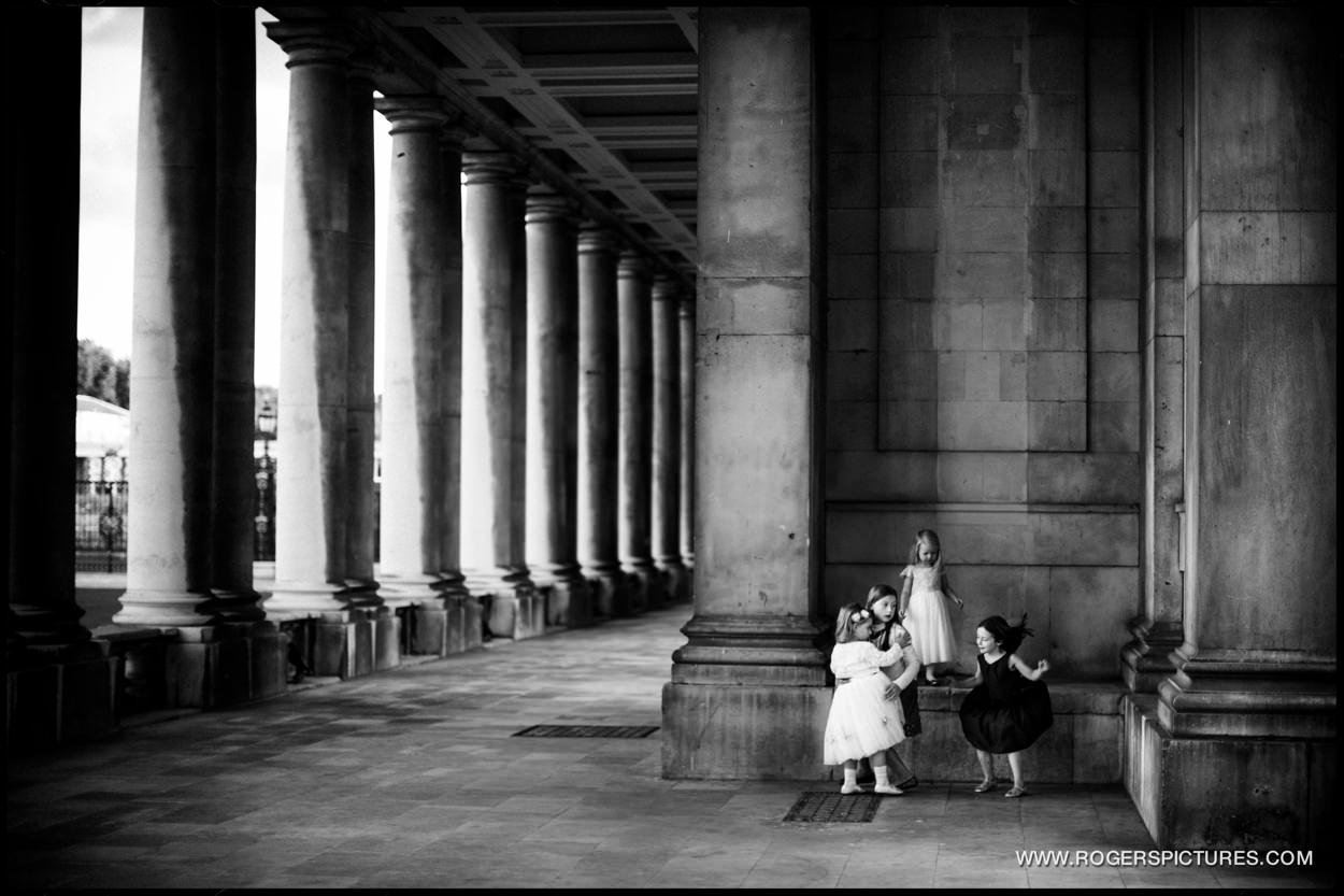 Children playing amongst the columns at the Old Royal Naval College in Greenwich