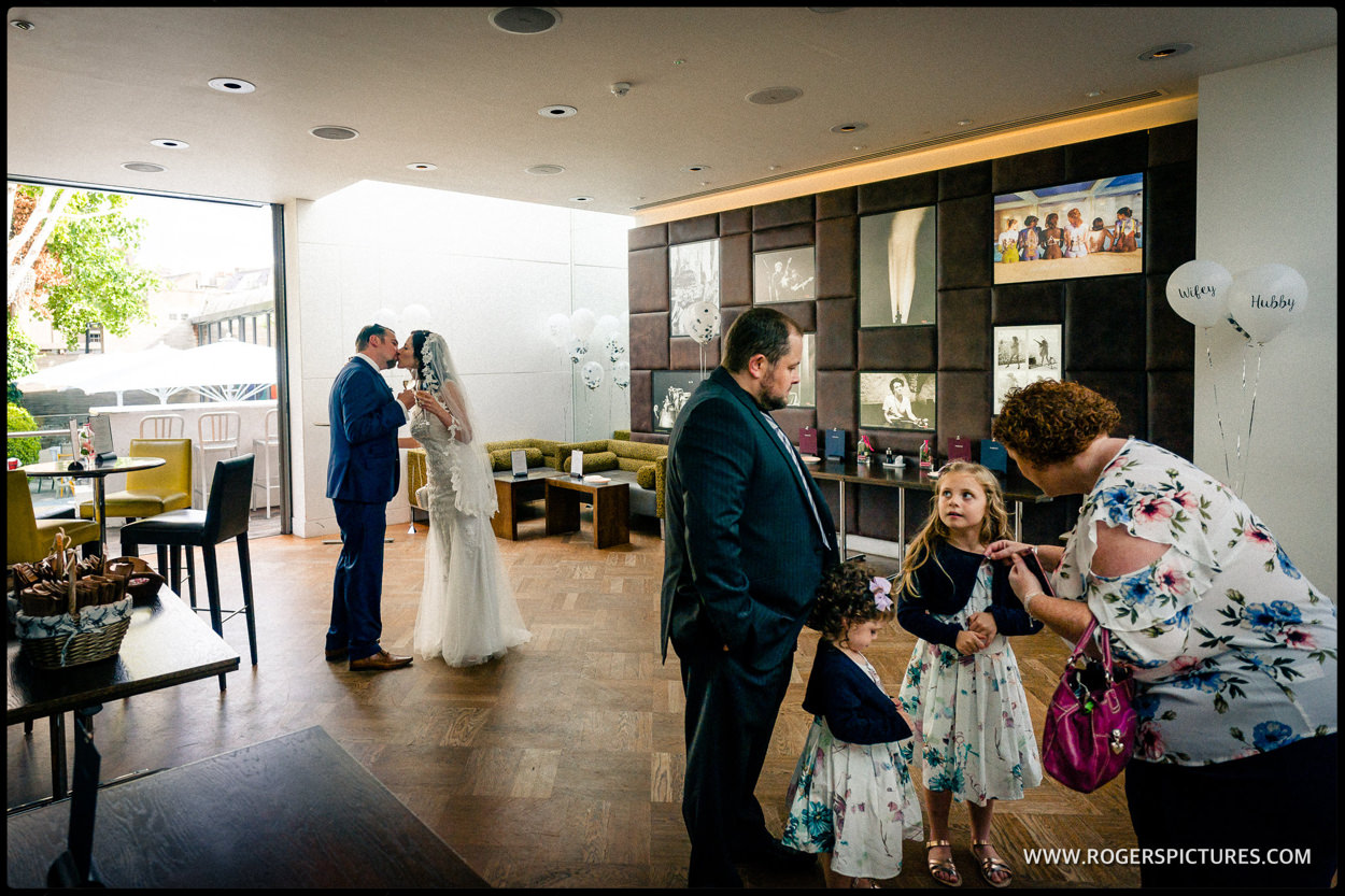 Bride an groom kiss at wedding reception at Fredericks Restaurant in Islington
