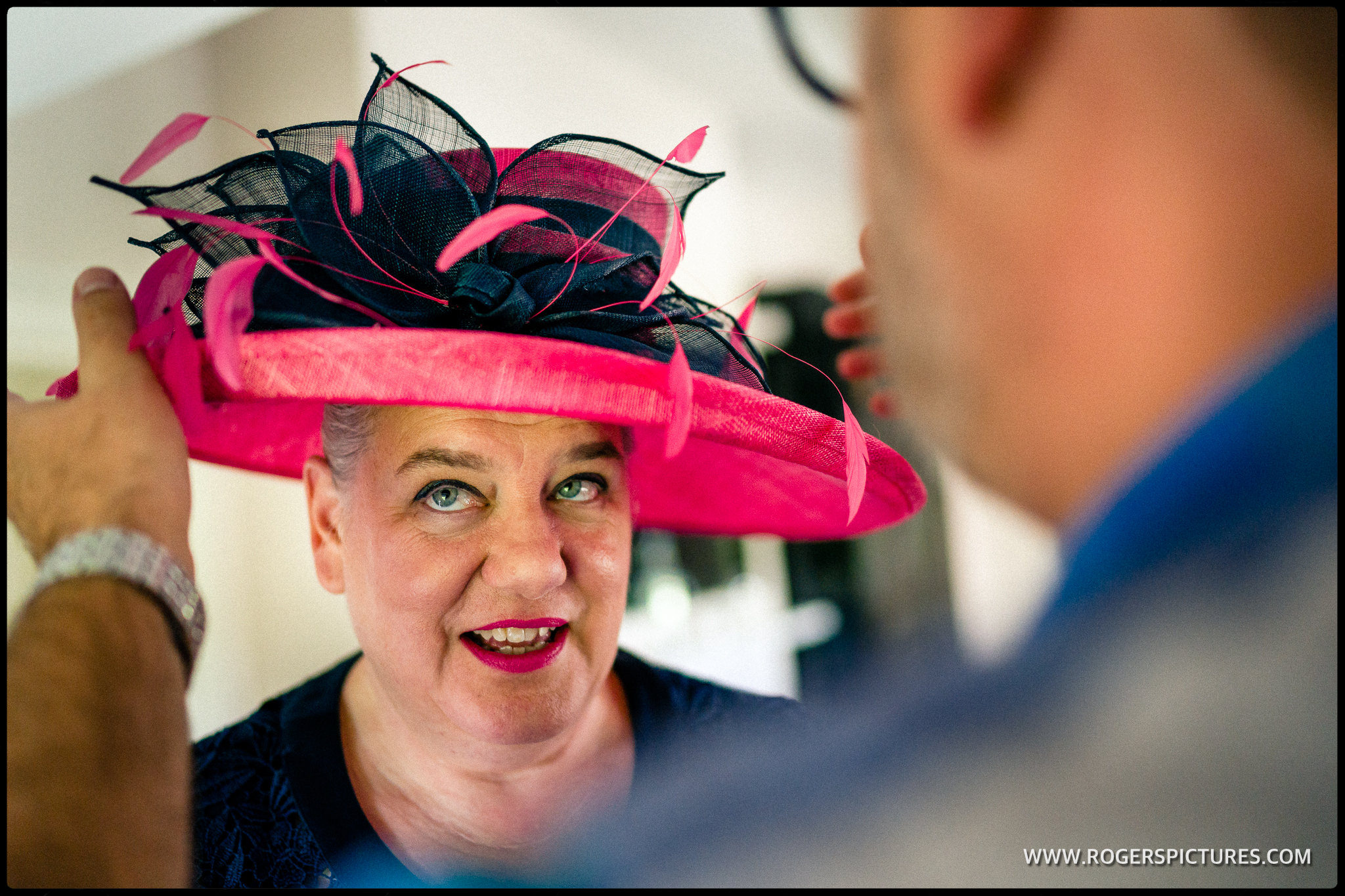 Mother of the groom in a red hat