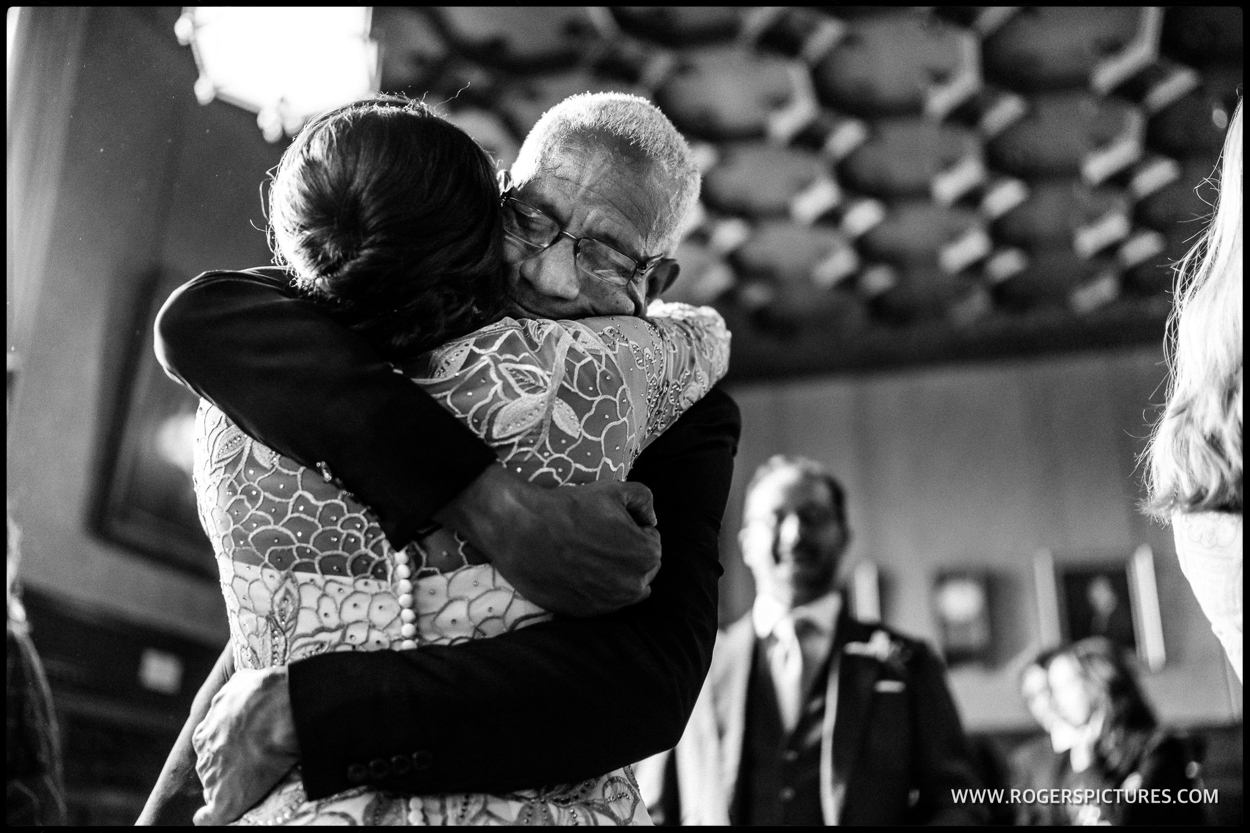 Father hugs his daughter after a wedding ceremony