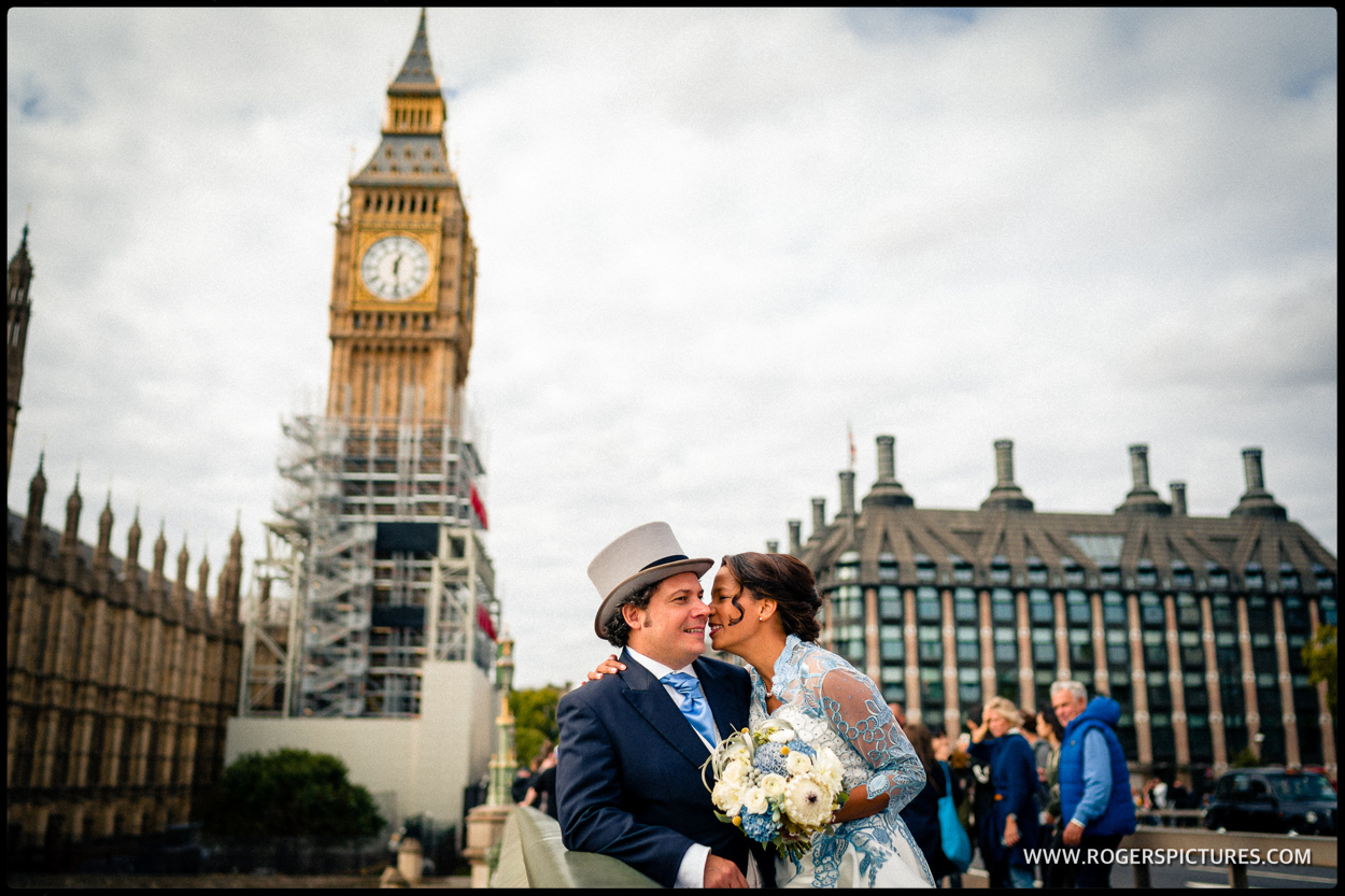 Newly married couple on Westminster Bridge with Big Ben and Parliament