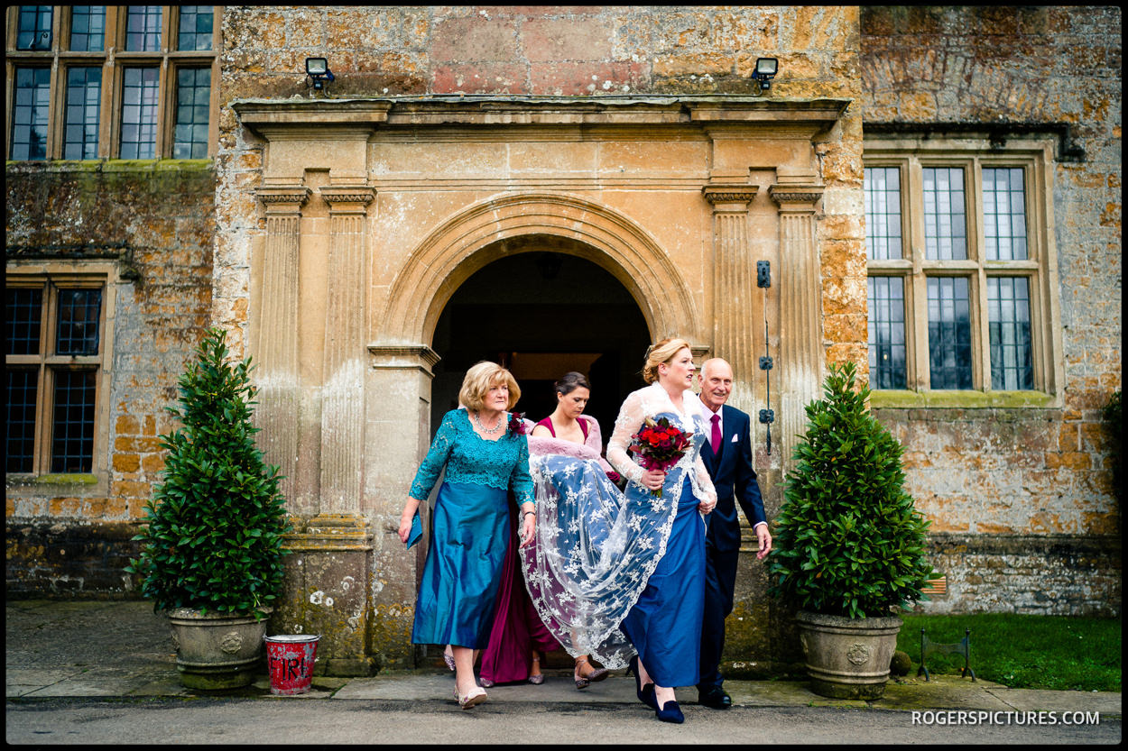 Bride and bridesmaids leave at North Cadbury Court on their way to the ceremony