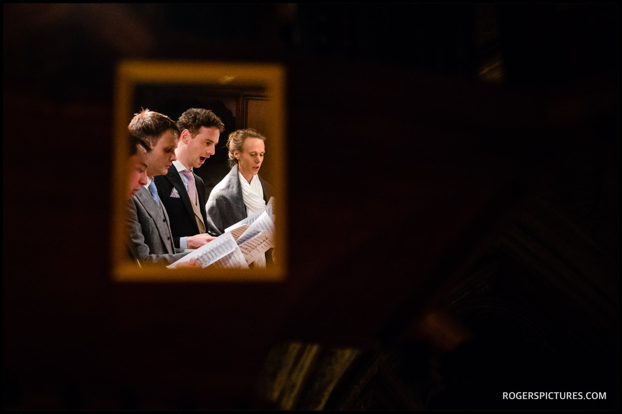 Wedding guests singing at at St Etheldreda’s Church in London