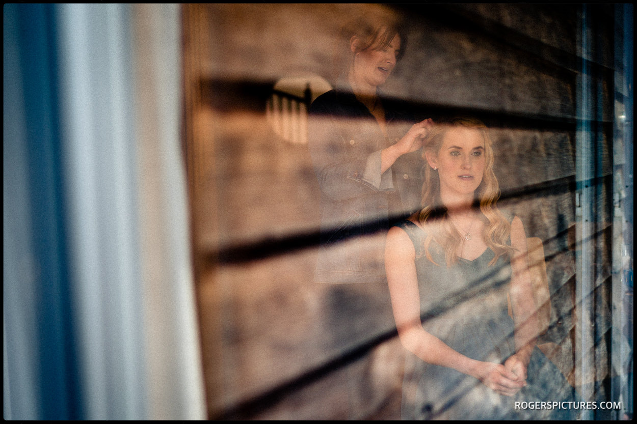 Brides prep before a barn wedding