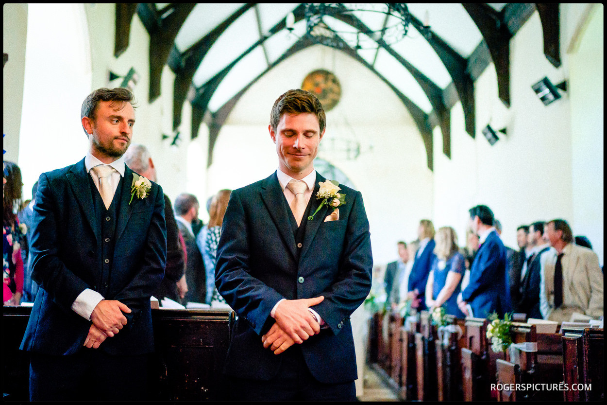 Groom waits nervously during a church wedding