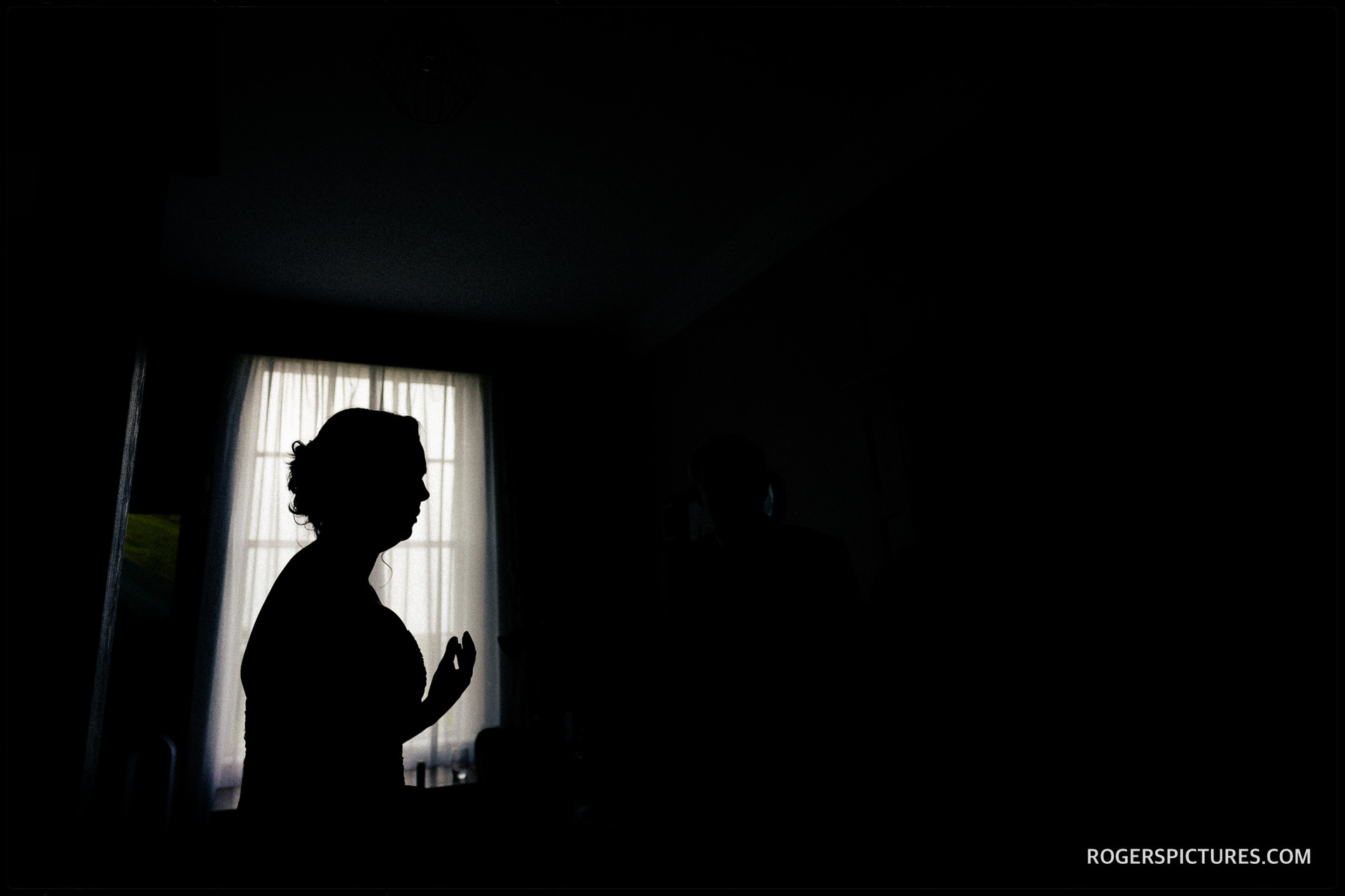 Silhouette of a bride getting ready