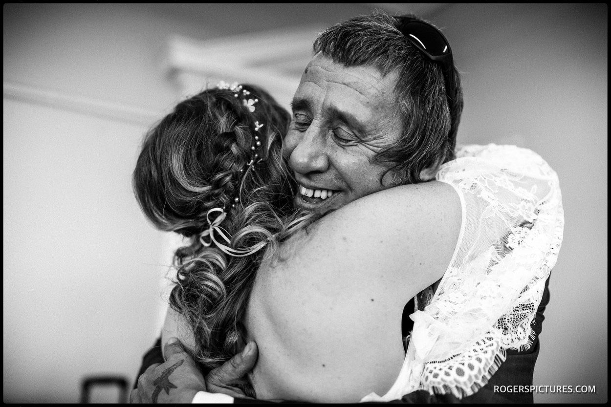 Father hugging daughter on her wedding day