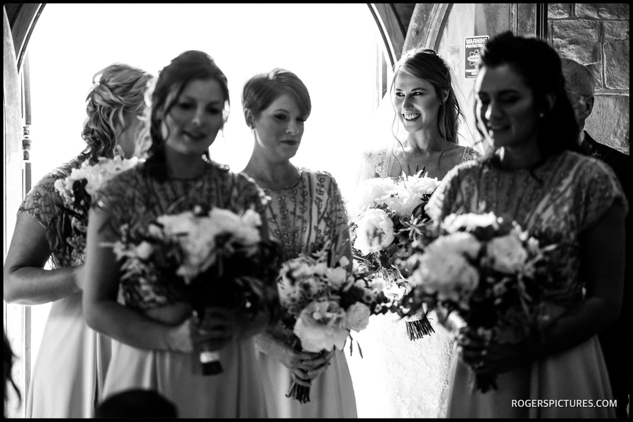 Black and white wedding photograph in the church doorway