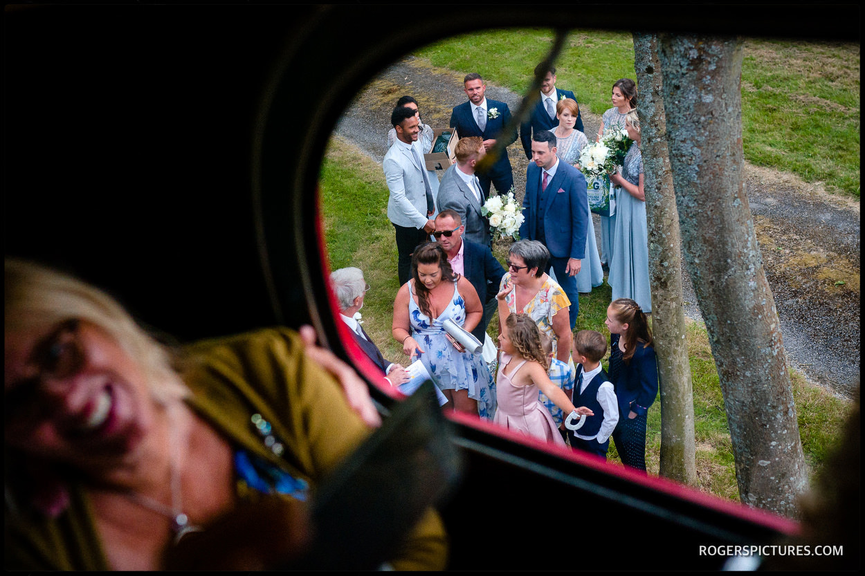 Wedding guests board a bus for Leeds Castle