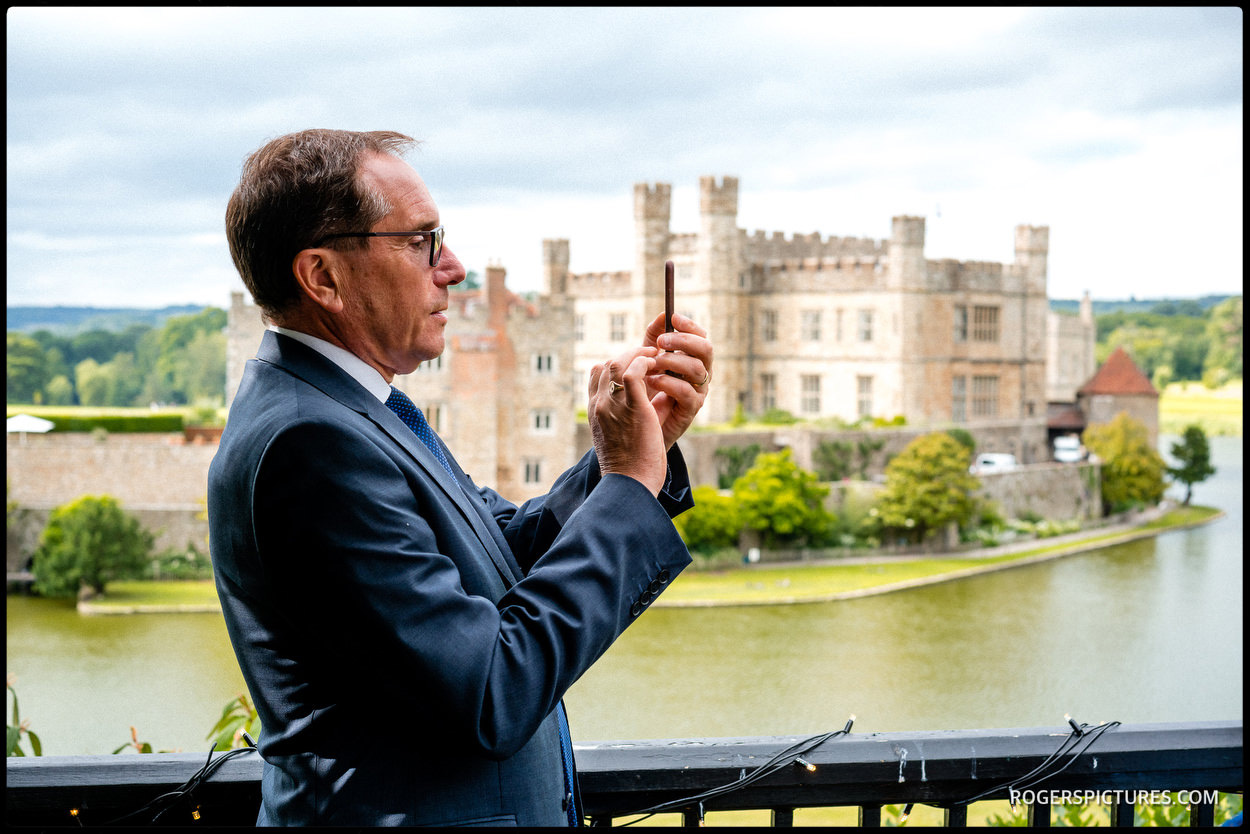 Guest taking a picture at Leeds Castle wedding