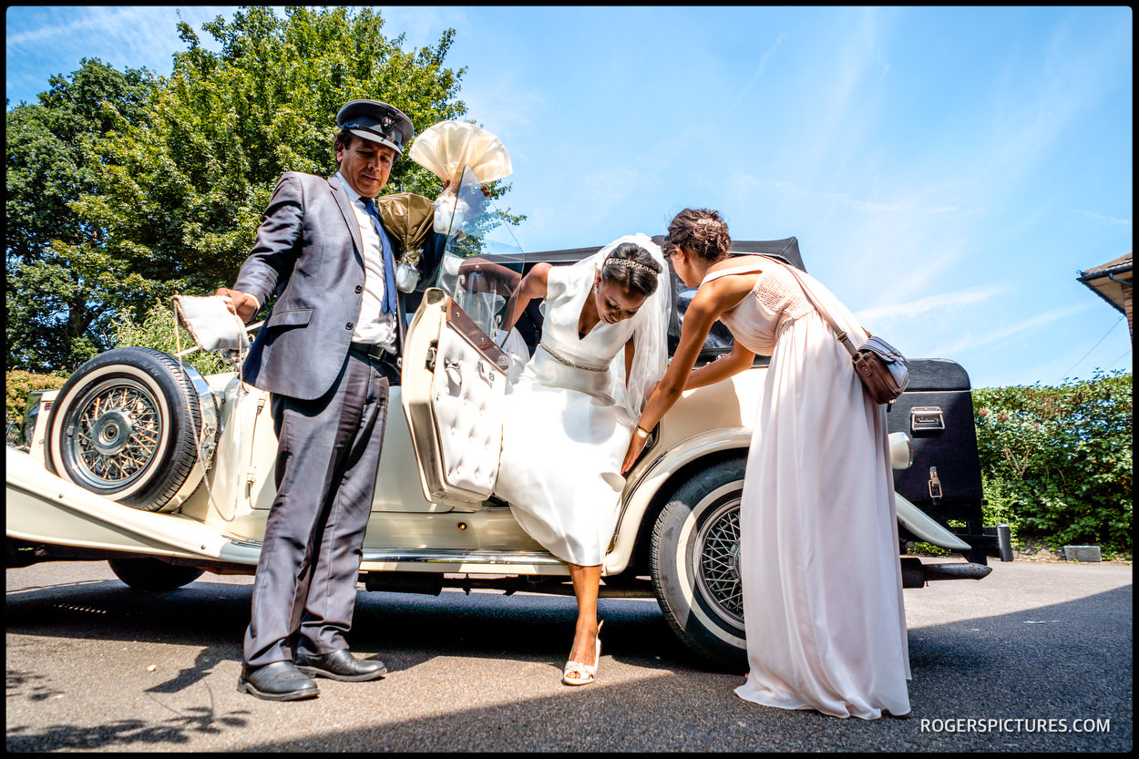 Bride arrives in vintage wedding car