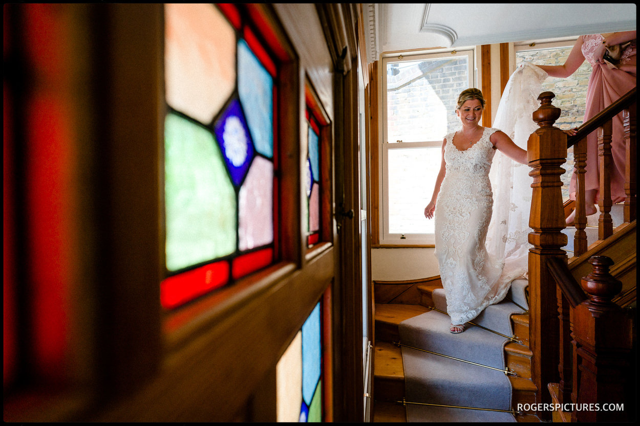 Bride in her wedding dress on stairs