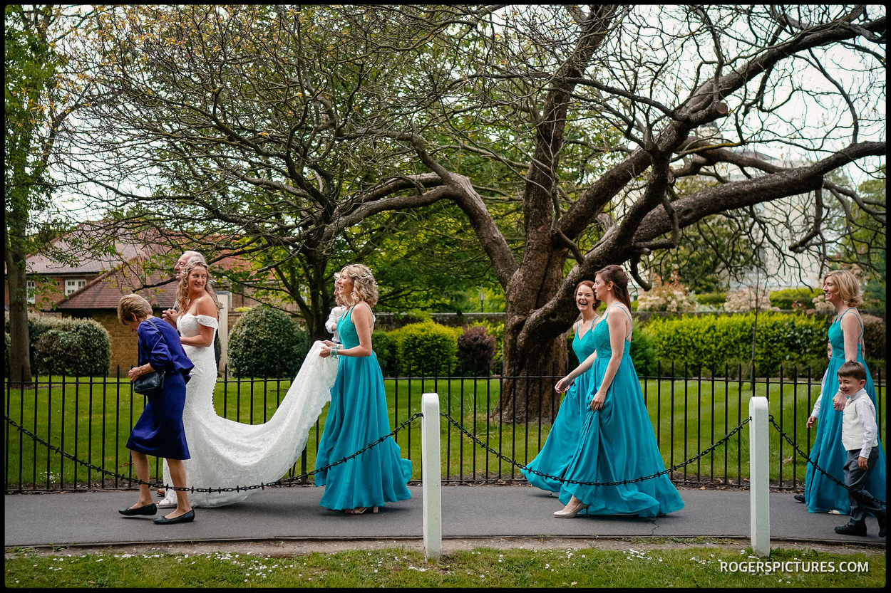 Bridesmaids and bride walk to Dulwich College for the wedding ceremony