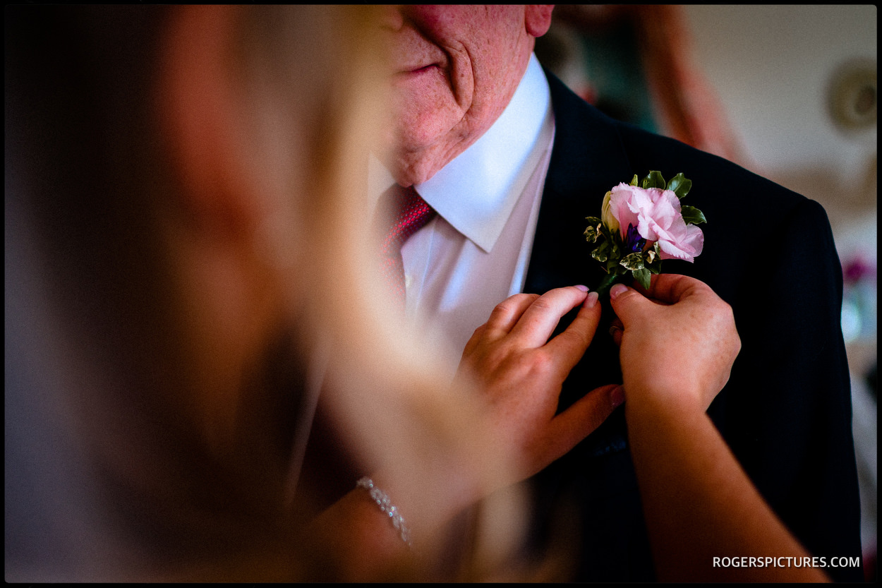 Attaching a wedding button hole