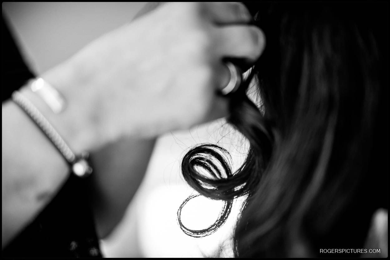 Detail photo of bride having hair prepared