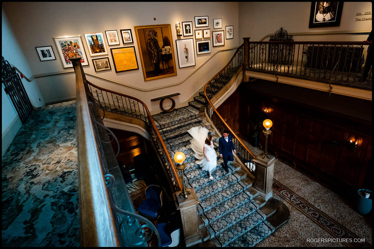 Bride and groom on grand staircase at Dixon Hotel wedding