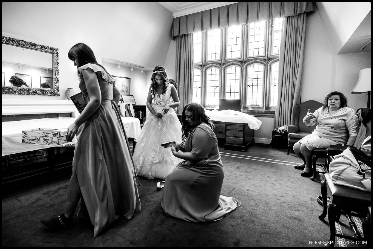 Bridal Preparations at Gray’s Inn – A candid black and white moment of the bride and her bridesmaids getting ready in an elegant room with large windows.