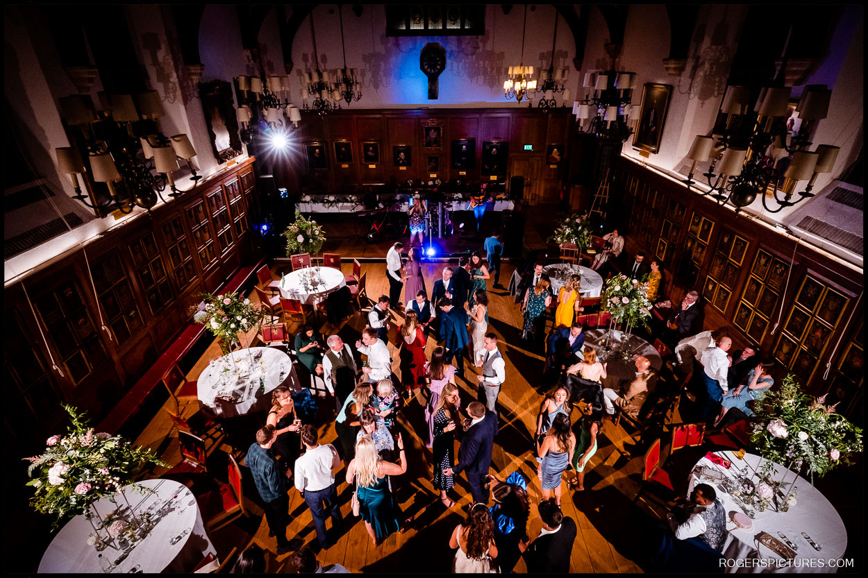 Evening Wedding Reception at Gray’s Inn – A stunning aerial view of the reception hall, filled with guests dancing and celebrating under elegant chandeliers.