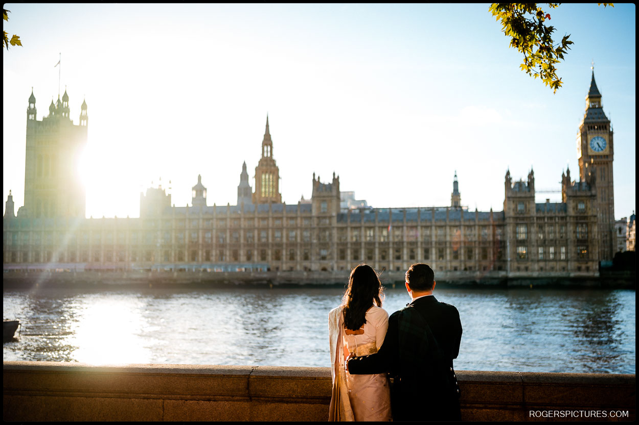 Short London Wedding at Hendon Town Hall - Bride and groom admire the view of the Houses of Parliament and River Thames at sunset after their Short London Wedding at Hendon Town Hall.