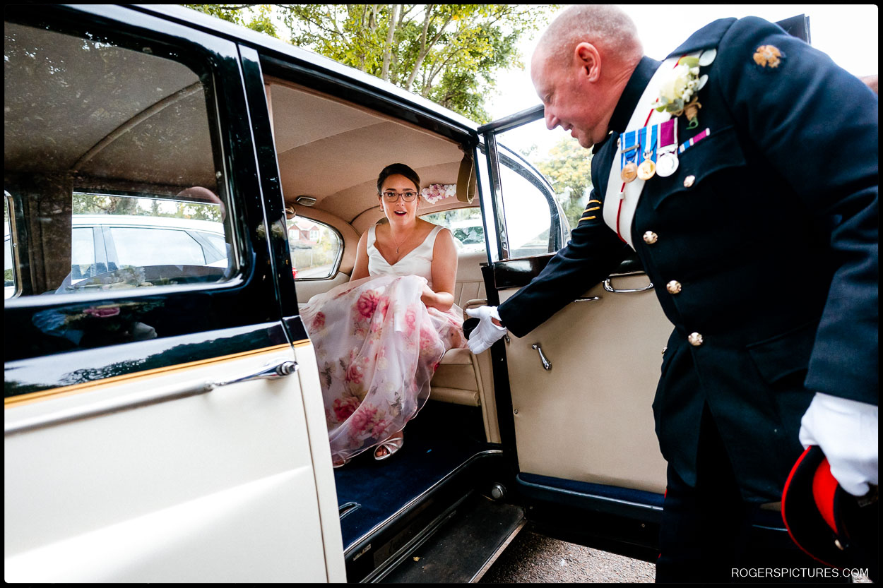 Bride arrives at church in vintage wedding car