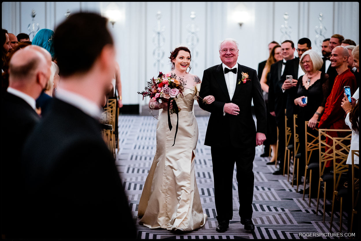 Proud Father and Bride walk down the aisle at Winter wedding at Claridges