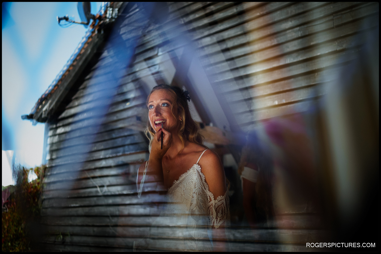 Documentary wedding photograph of a bride getting ready before an outdoor wedding ceremony