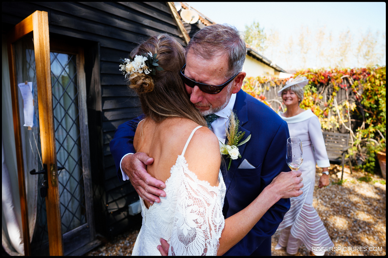 father of the bride greets his daughter before wedding ceremony