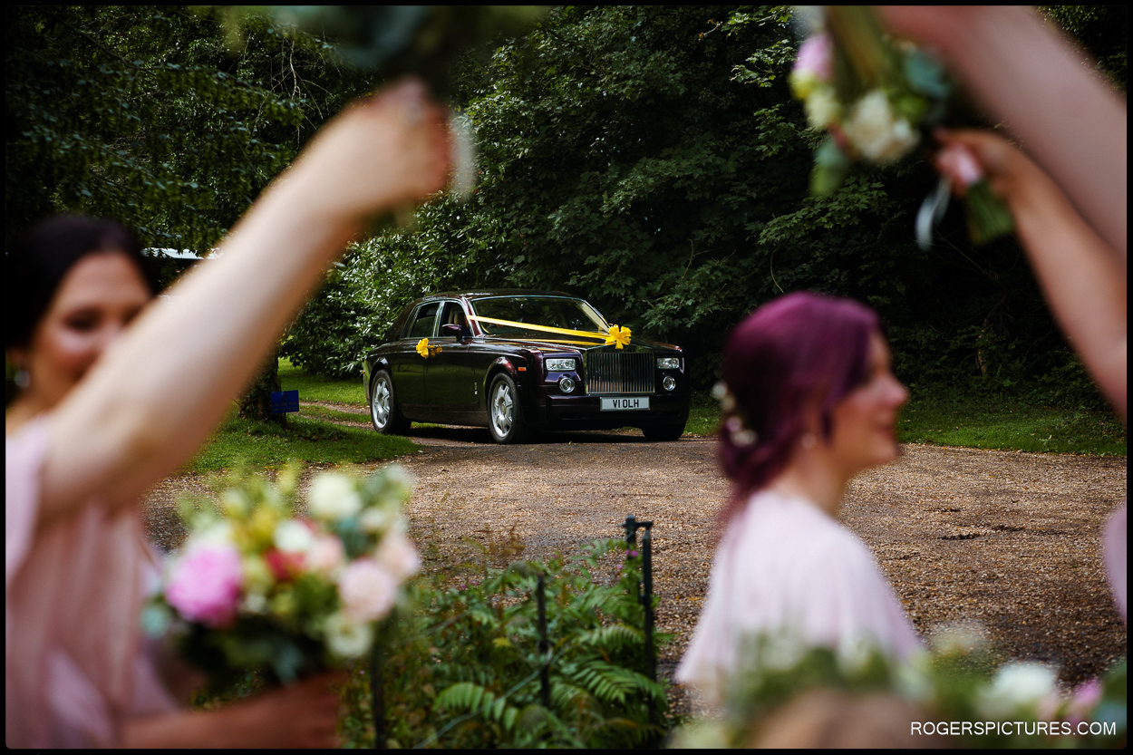 Bride arrives for a church wedding in a Rolls Royce car