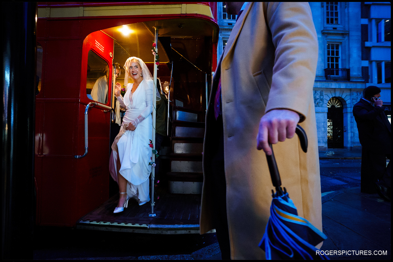 Bride stepping off London doube decker bus