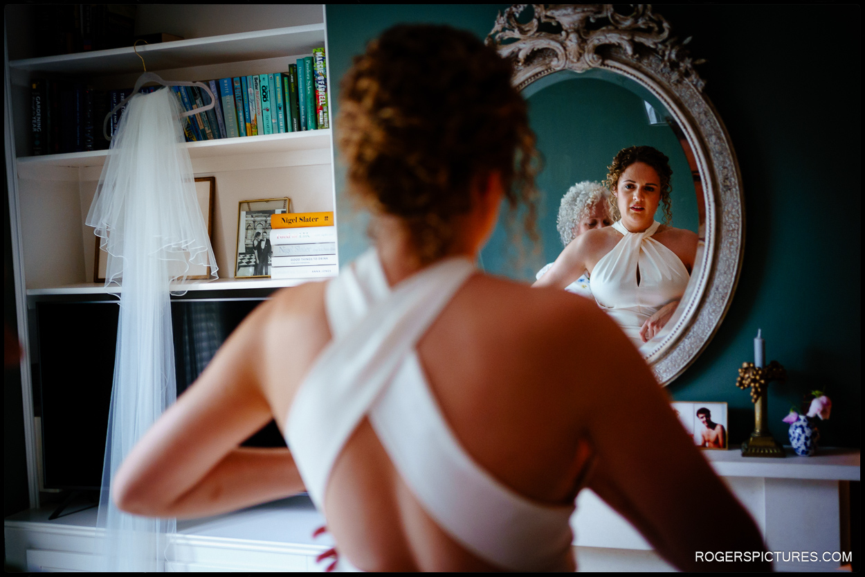 Bride reflected in a mirror in her wedding dress