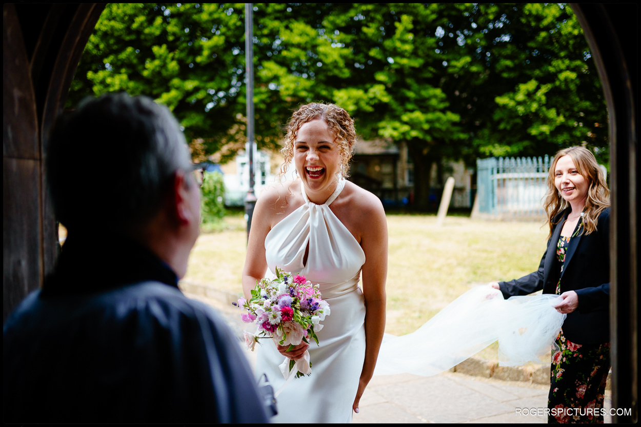 Laughing bride arrives at Farnham Church