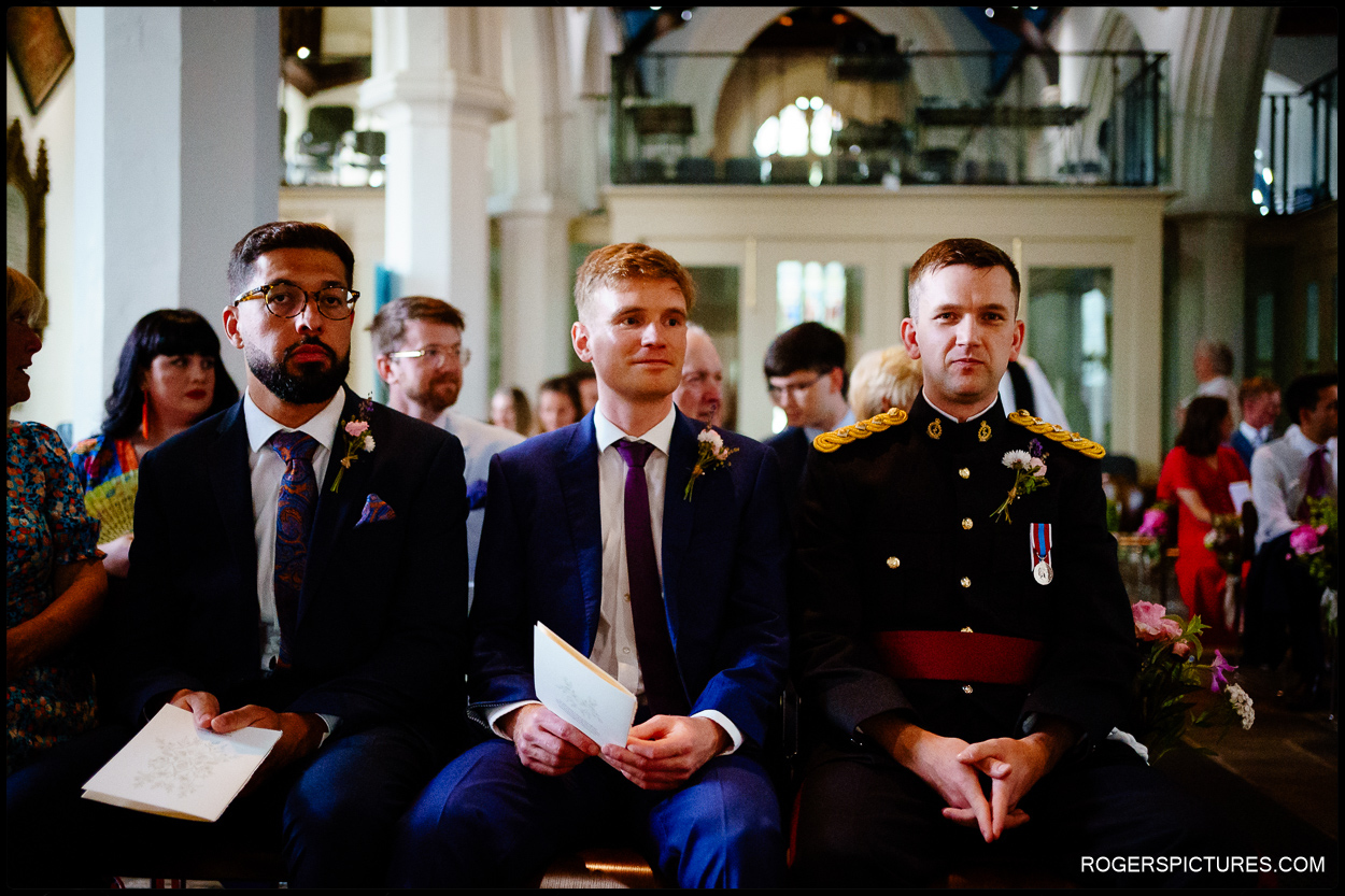 Groom waits nervously with groomsmen before a church wedding ceremony