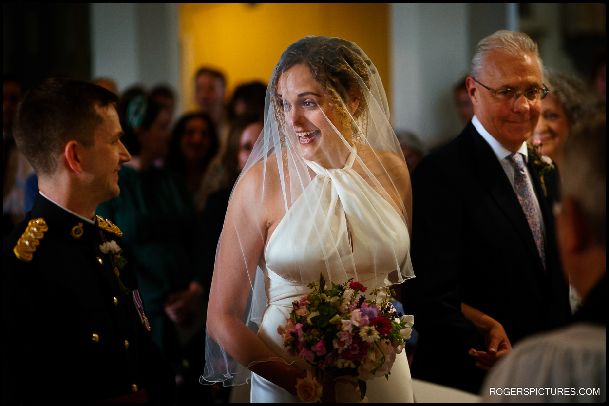 Bride in veil arrives to marry in church