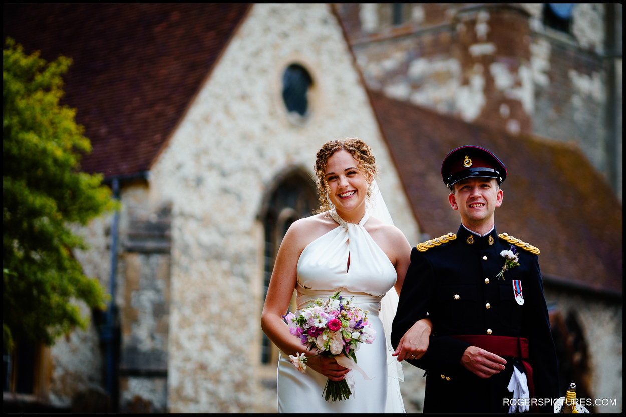 Newly married couple outside church in Farnham