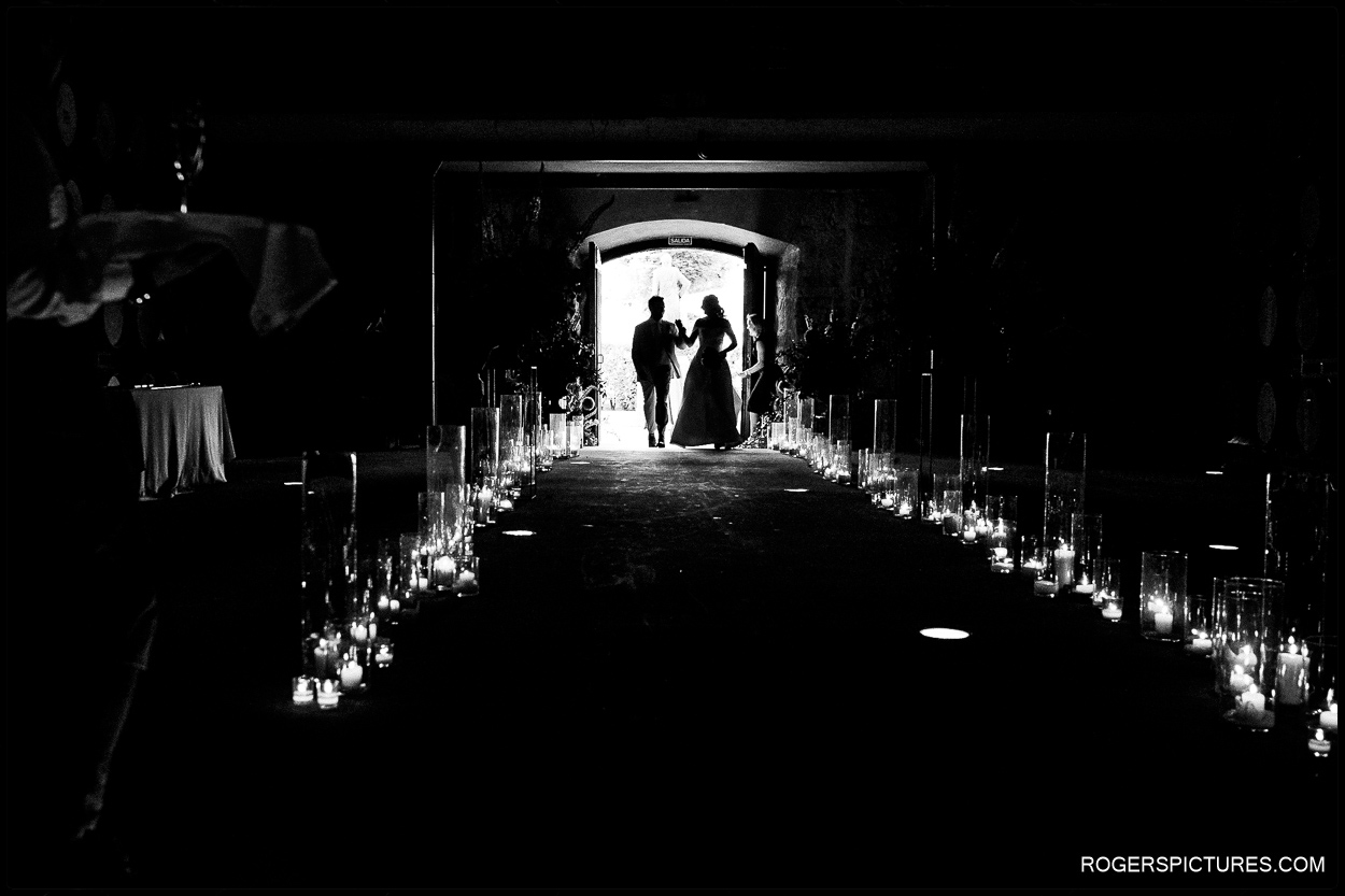 Black and white silhouette of newly wed couple entering the wedding reception