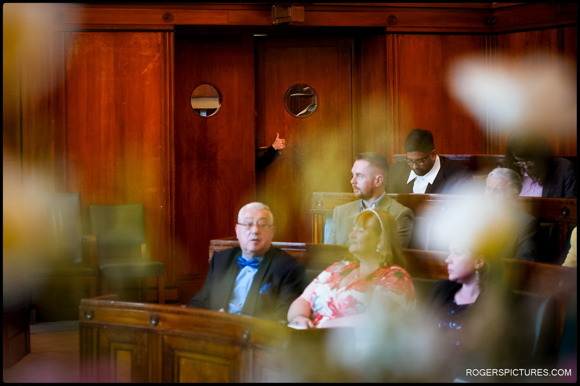 London Wedding at Town Hall Hotel – A playful thumbs-up from a guest peeks through the ceremony doors at Town Hall Hotel.