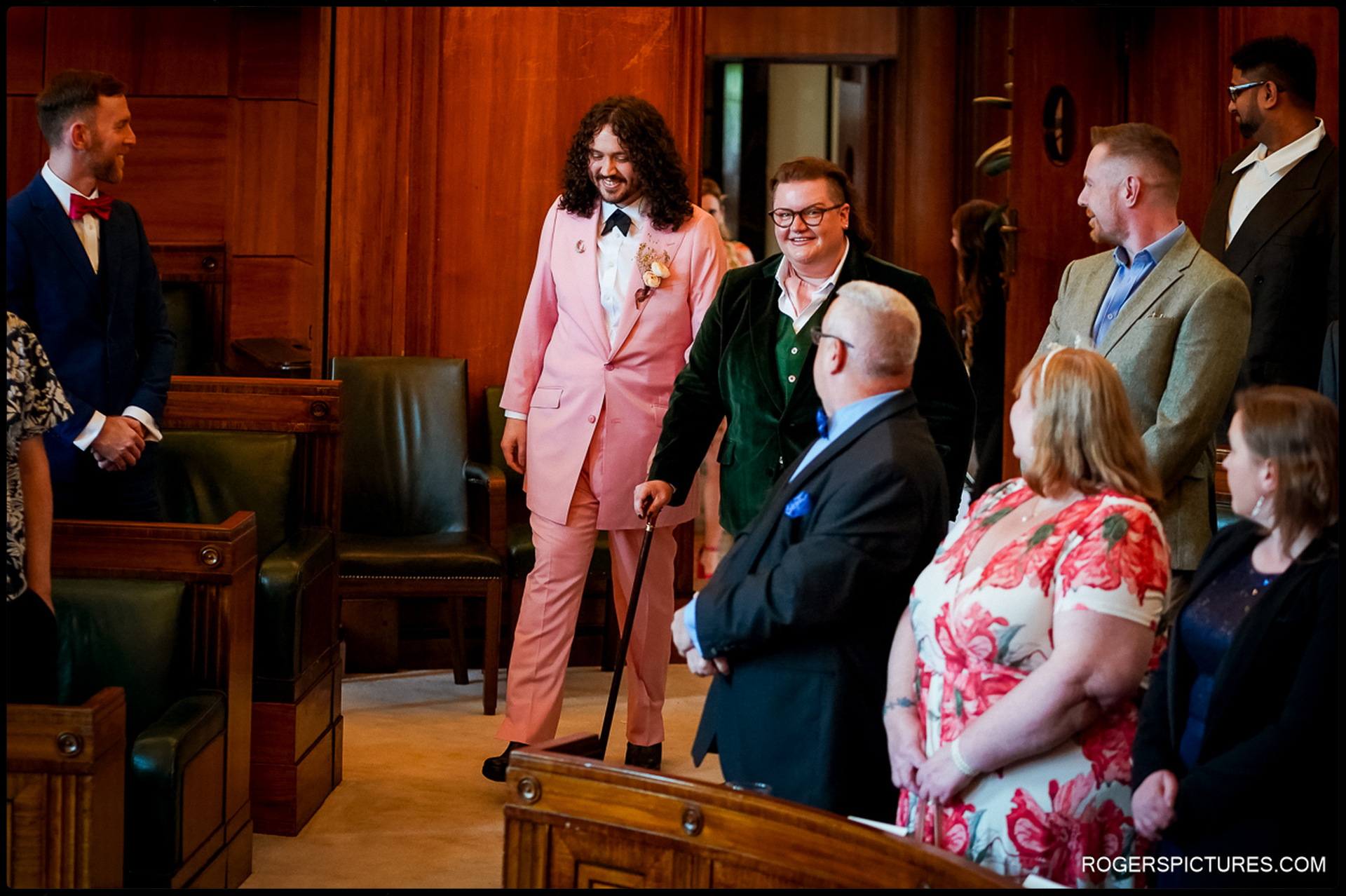 London Wedding at Town Hall Hotel – The grooms walk down the aisle together, greeted by smiling guests in the historic ceremony room.