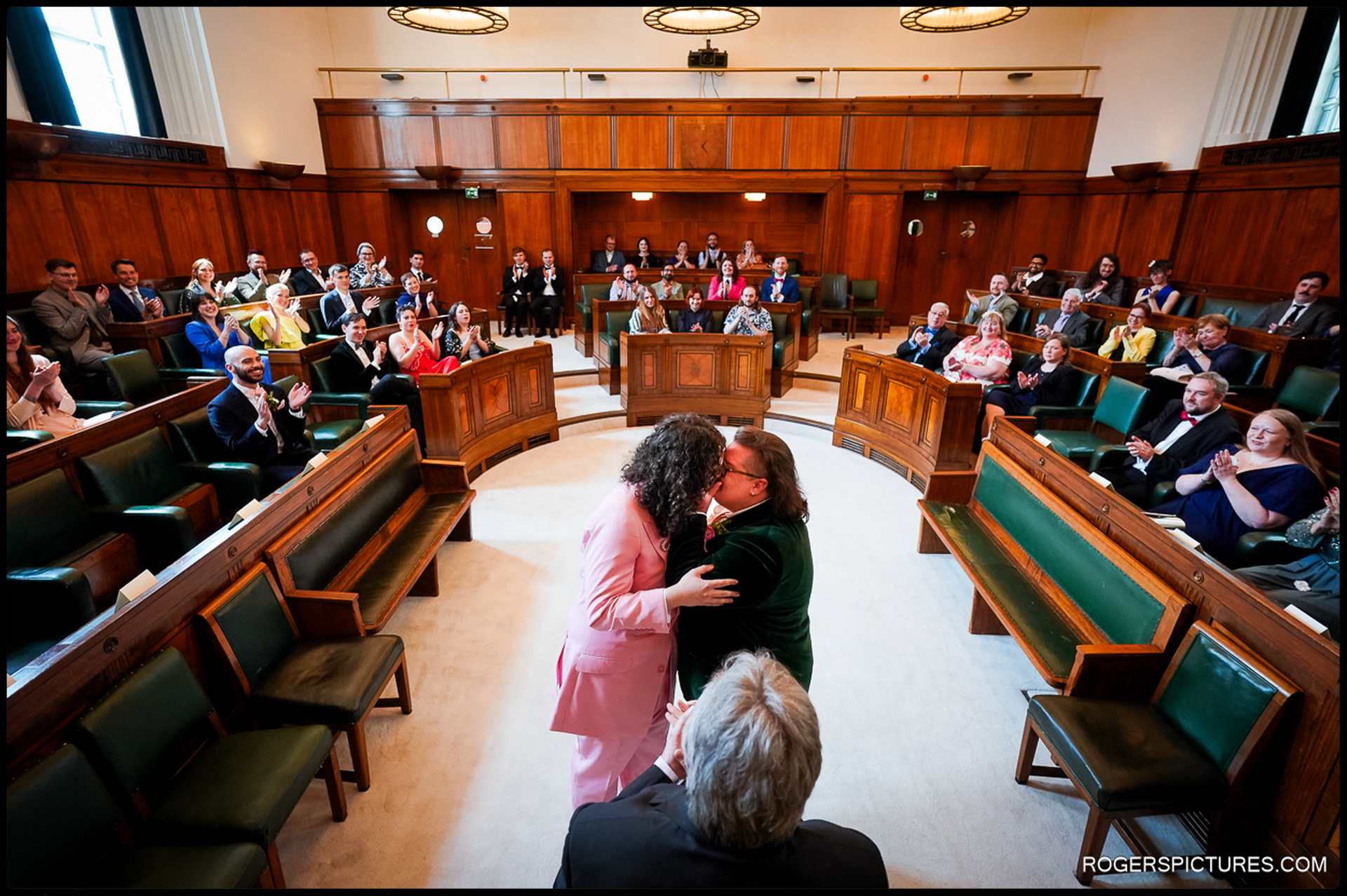 London Wedding at Town Hall Hotel – The newlyweds share their first kiss in the grand council chamber, surrounded by cheering family and friends.