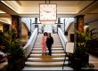 London Wedding at Town Hall Hotel - The couple stands together at the grand staircase of the Town Hall Hotel, framed by elegant Art Deco interiors.