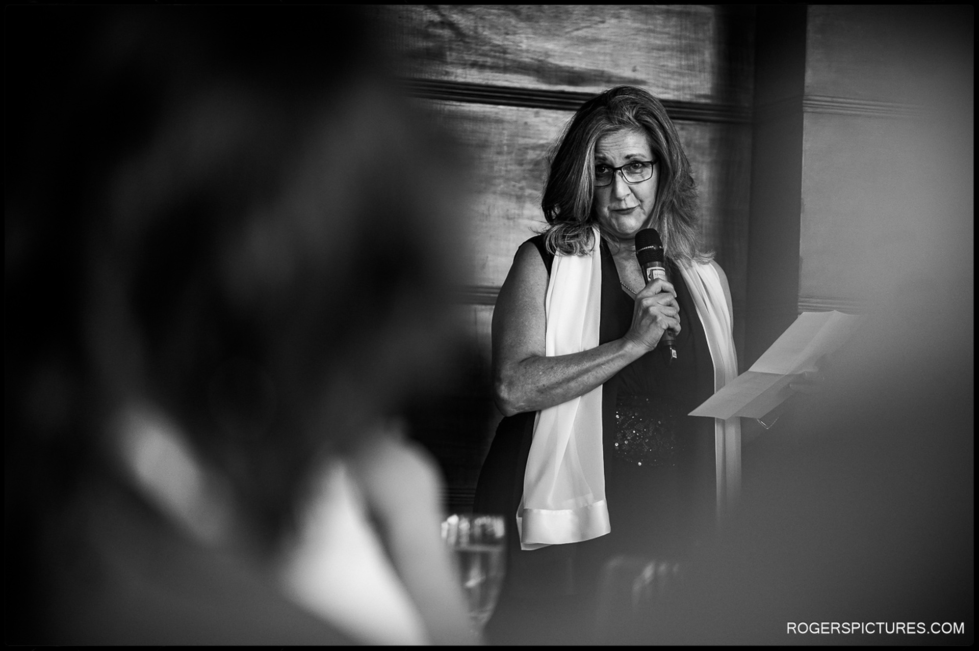 A wedding speech in progress, with an emotional speaker addressing the guests with heartfelt words.