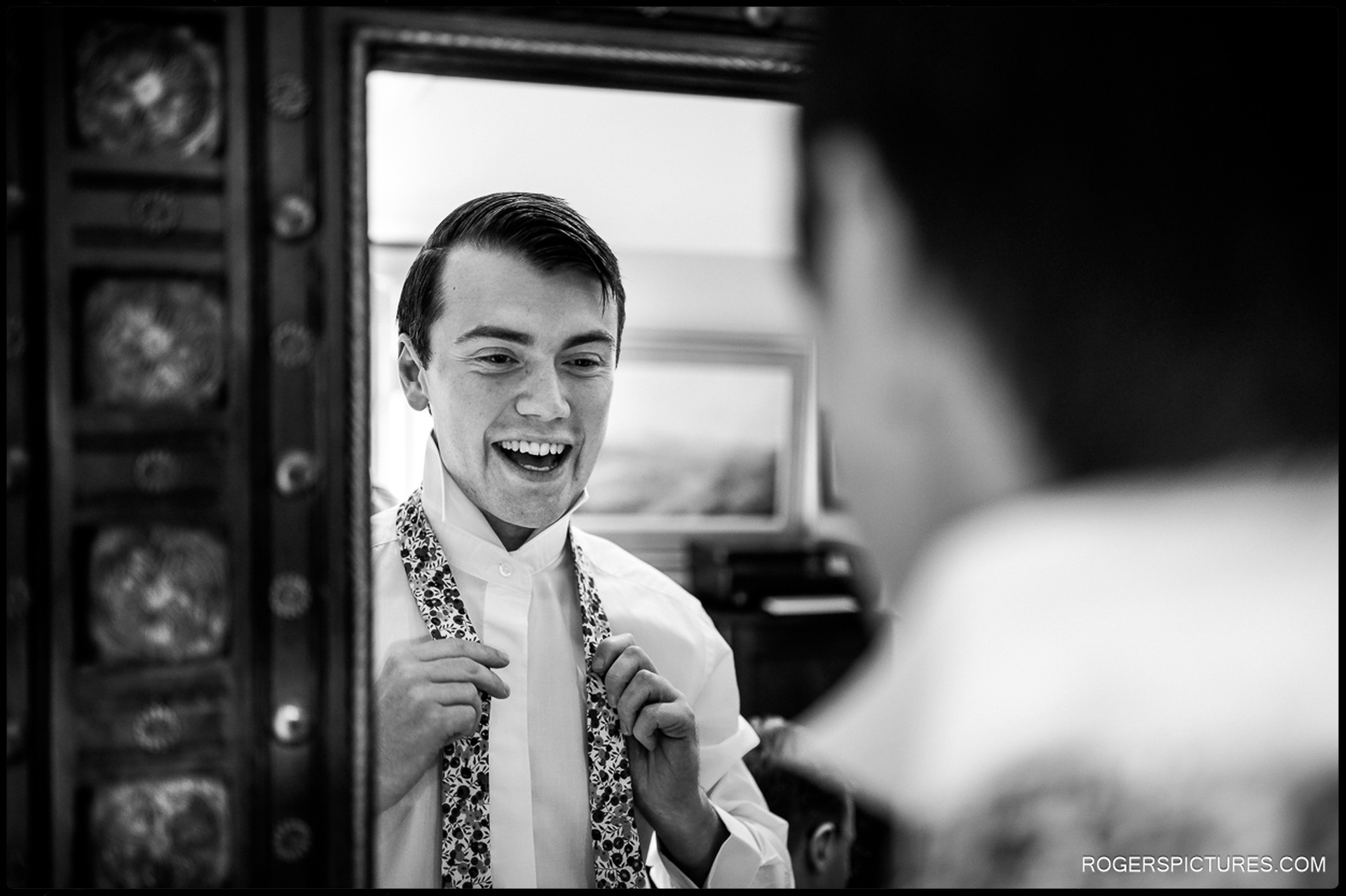 Documentary photo of groom getting ready for church wedding