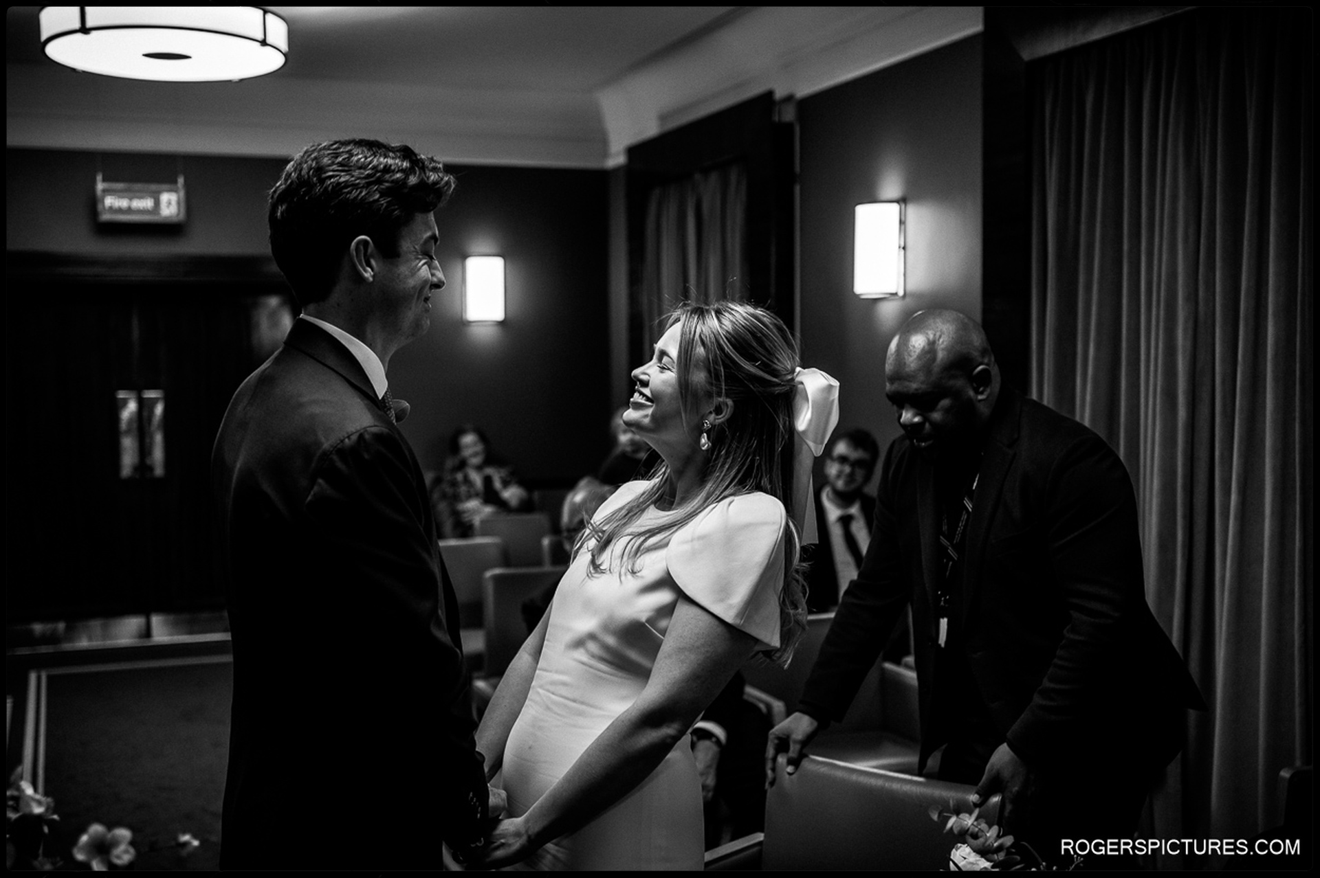 Bride and groom exchanging smiles during their intimate wedding ceremony at Hackney Town Hall.