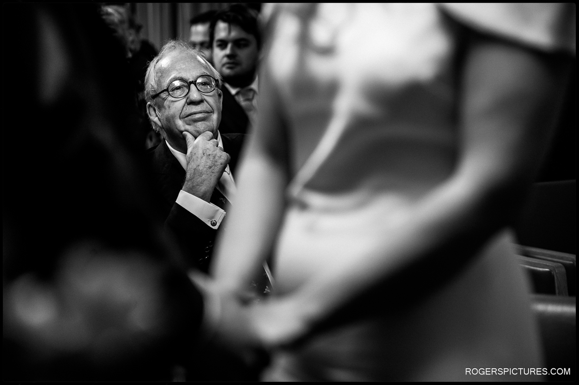 Father of the bride watching the ceremony with a thoughtful expression at Hackney Town Hall.