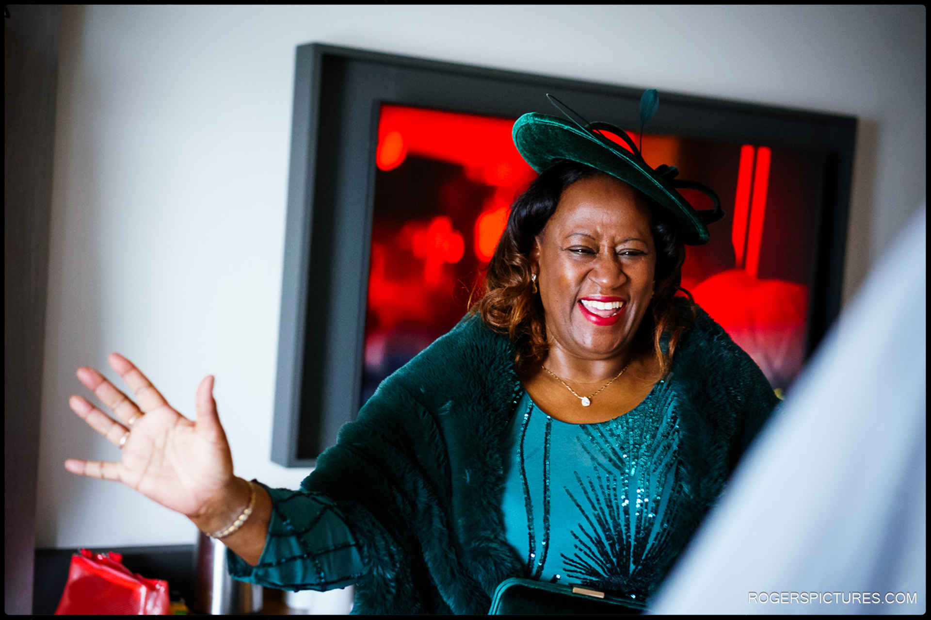 Mother of the bride smiling and waving during bridal preparations