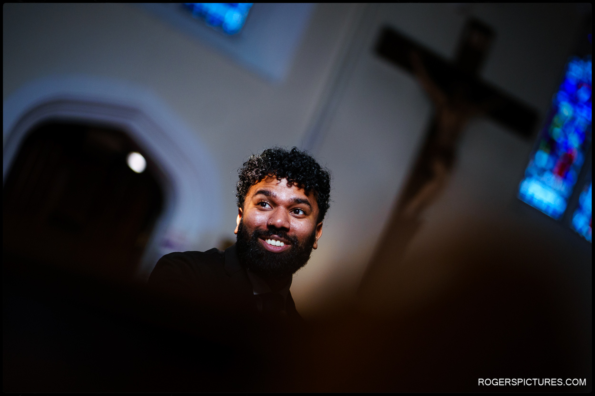 Best man smiling inside Church of St Mary Mother of God during the wedding