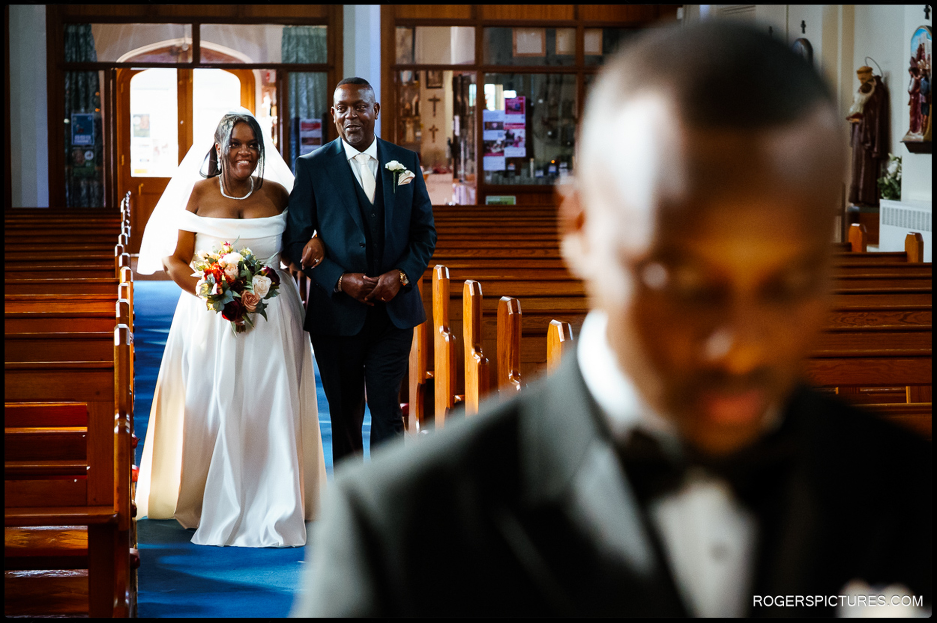 Bride walking down the aisle with her father at the Church of St Mary Mother of God