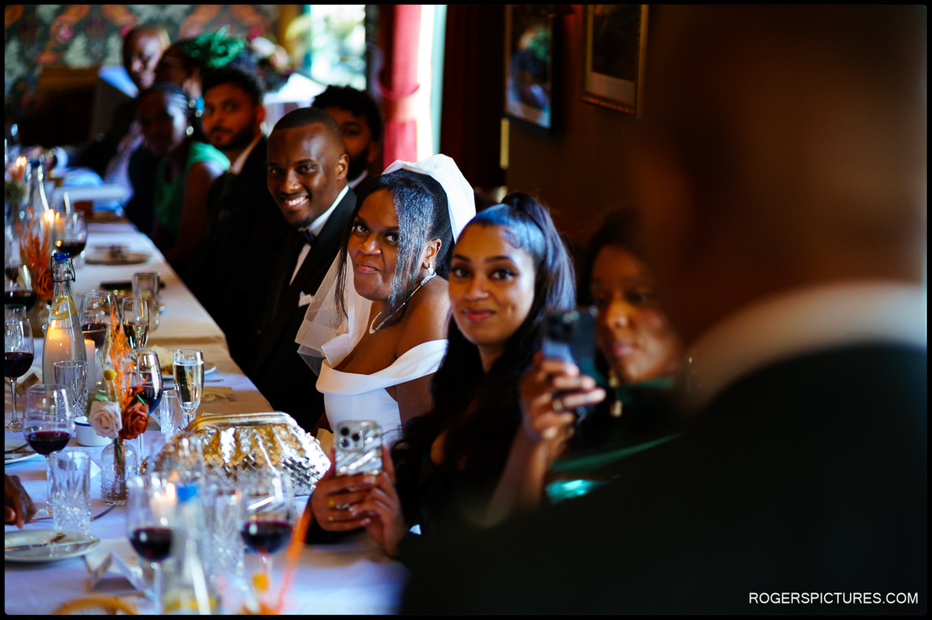 Bride smiling during a speech at the wedding reception at a London pub