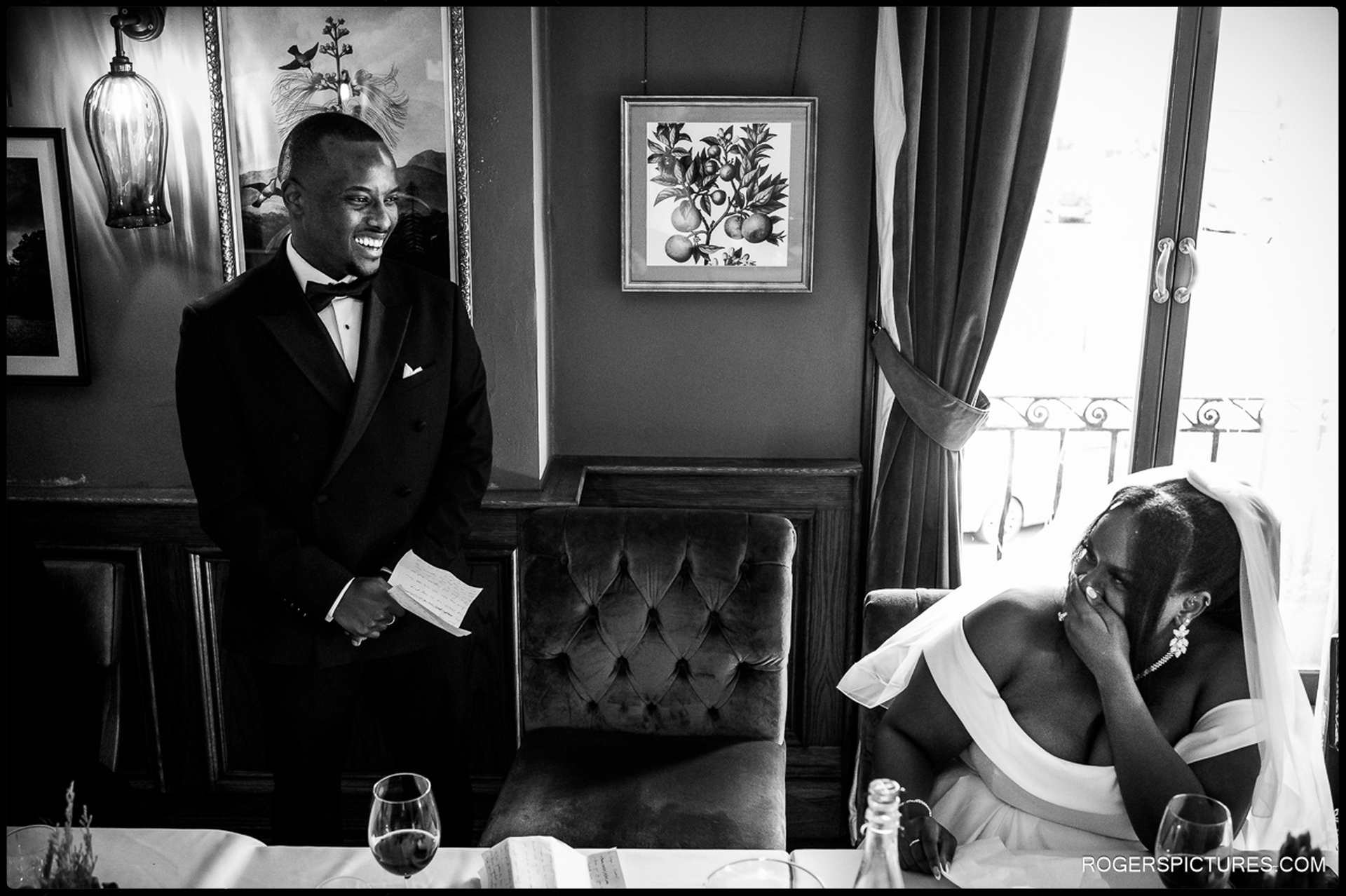 Groom delivering his speech while the bride reacts emotionally during reception