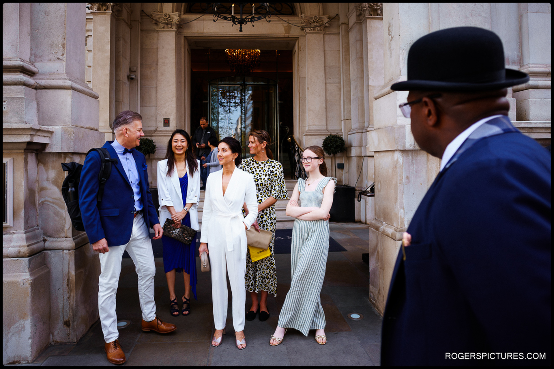 The bride and her wedding party gather outside The Langham, London, ready to head to the ceremony.